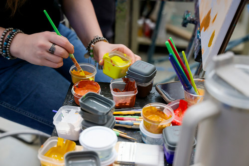 students painting hands